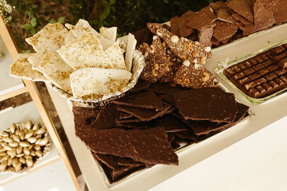 Indulge in a gourmet display of assorted chocolates and nut-topped treats.